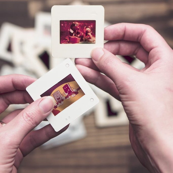 Person Holding Photos